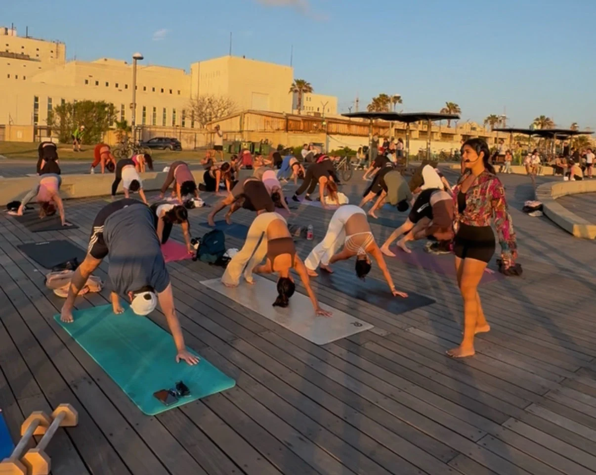 Rebecca Mardi leading an outdoor therapeutic yoga session for a group.