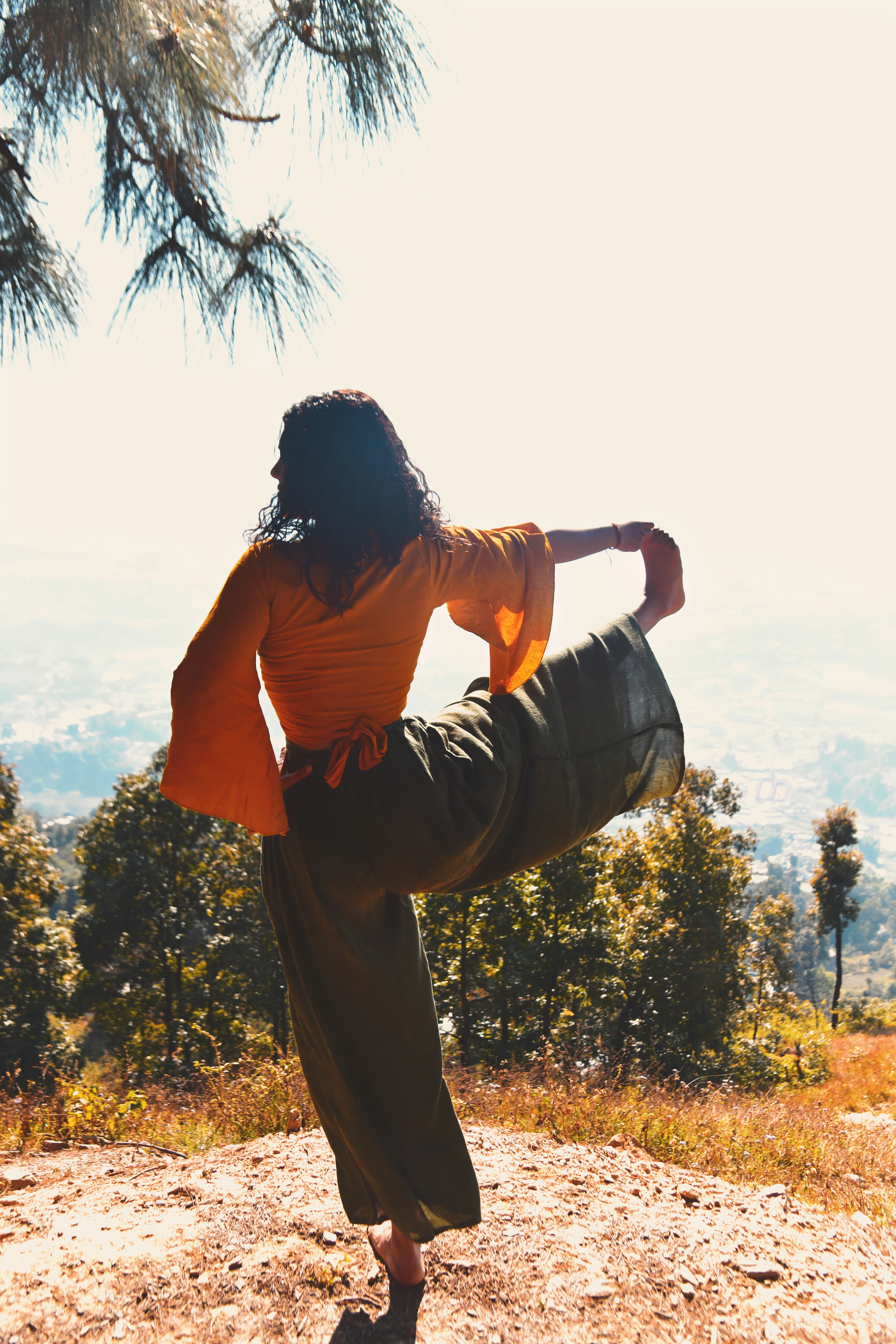 Rebecca Mardi practicing a precise alignment-focused yoga pose outdoors.